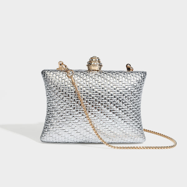 Small structured rectangular metallic woven-texture clutch bag with jeweled knob clasp and gold-tone chain strap, detail view