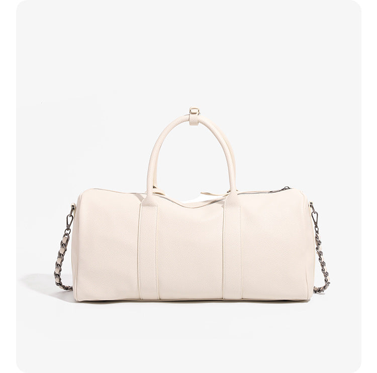 Large cream white pebbled leather-look barrel travel bag with twin top handles, chunky chain shoulder strap, front zip
