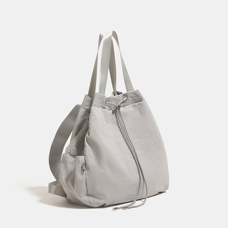 Glacier gray grid-texture nylon drawstring bucket convertible backpack with top handles and adjustable shoulder straps