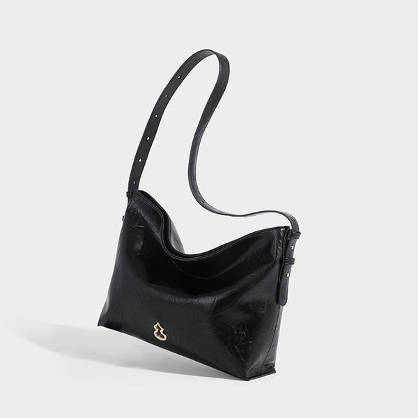 Large slouchy hobo shoulder bag in glossy crinkle leather-look finish with gold-tone emblem hardware and adjustable strap
