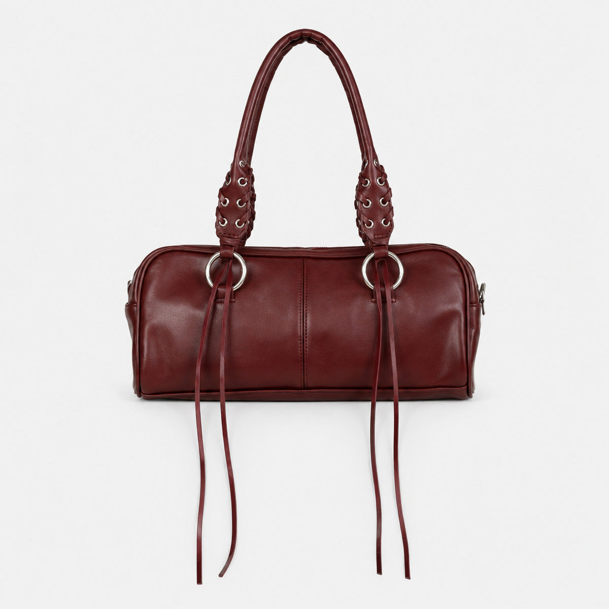 Rectangular suede-look barrel bag with laced eyelet handles, silver O-ring hardware, and hanging leather-look fringe tie