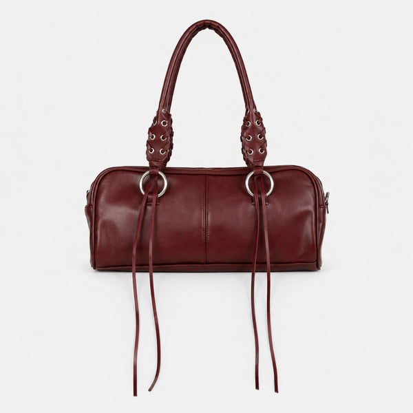 Rectangular suede-look barrel bag with laced eyelet handles, silver O-ring hardware, and hanging leather-look fringe tie