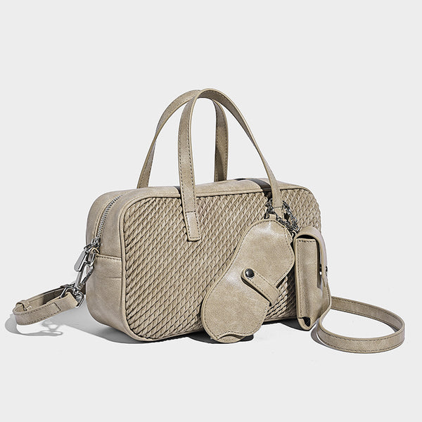 Structured woven-texture front top-handle handbag with zip closure, dual handles, detachable shoulder strap, and matching