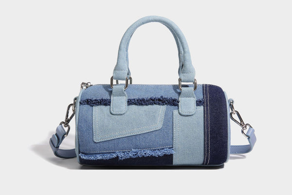 Mini barrel handbag in light and dark denim patchwork with frayed seam trim, dual top handles, top zip closure, and, detail