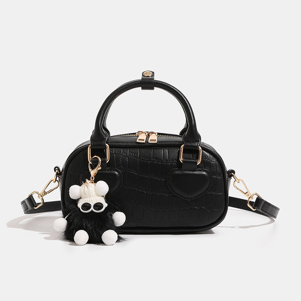 Mini croc-embossed barrel handbag with gold-tone hardware, dual zip top handles, detachable crossbody strap, and fluffy