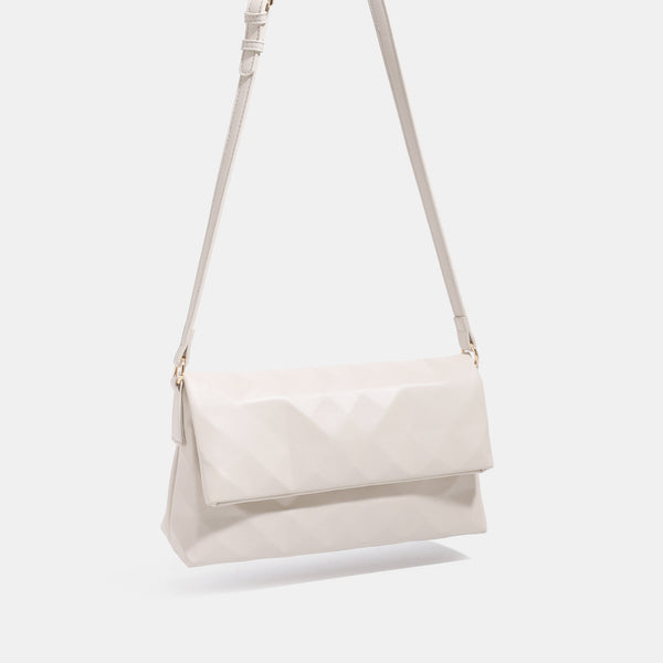 Geometric faceted flap shoulder bag with braided chain strap in black and ivory leather-look finish, detail view 3