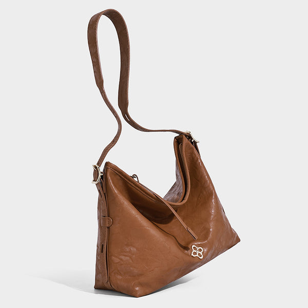 Slouchy leather-look hobo shoulder bag with gold-tone hardware and adjustable strap in brown, detail view 23
