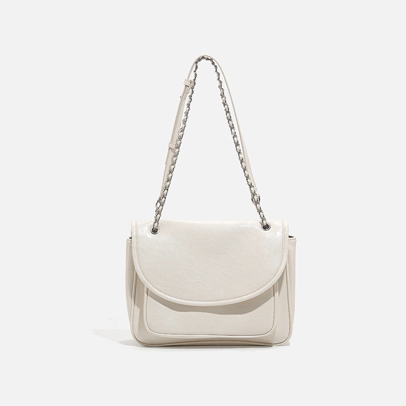 Structured glossy leather-look flap crossbody satchel with woven chain-and-leather shoulder strap, detail view 6
