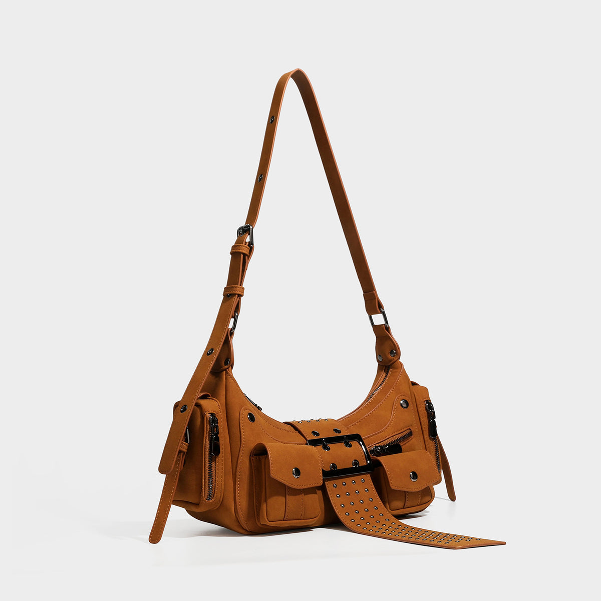 Brown matte suede-look shoulder bag with gunmetal stud hardware, front buckle tab, flap pockets, and adjustable crossbody