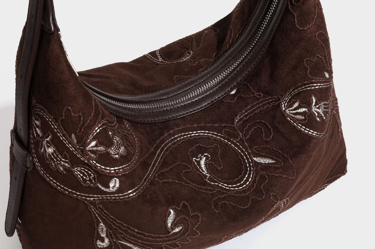 Deep chocolate suede-look hobo shoulder bag with tonal paisley floral embroidery, smooth dark leather-look trim, top zip