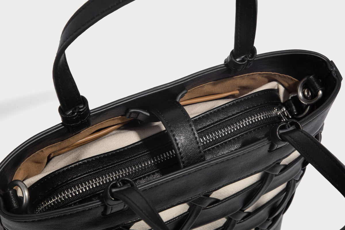 Structured woven lattice tote bag with cream lining, dual top handles, detachable crossbody strap, and silver-tone hardware
