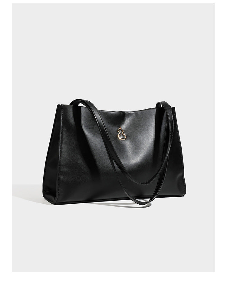 Structured rectangular shoulder tote bag with smooth leather-look finish, long double straps, and gold-tone gourd emblem on