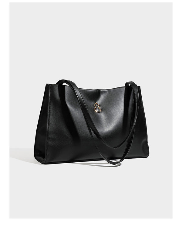 Structured rectangular shoulder tote bag with smooth leather-look finish, long double straps, and gold-tone gourd emblem on