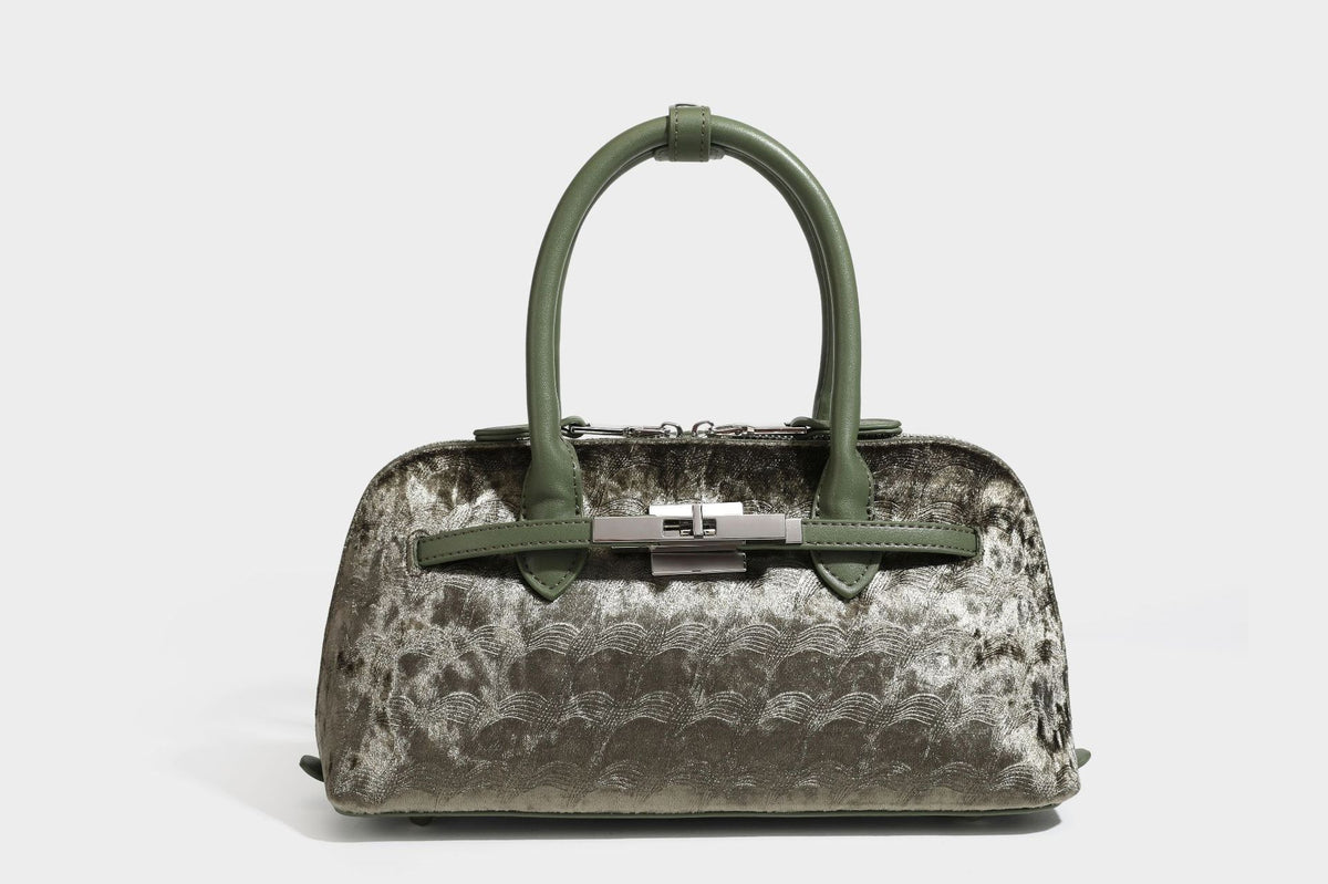 Small structured satchel bag in dark brown velvet-like textured finish with leather-look trim, silver-tone turn-lock bar