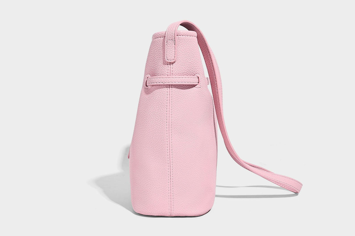 Small pebbled leather-look bucket bag with front drawstring toggle hardware and long adjustable shoulder strap, detail view