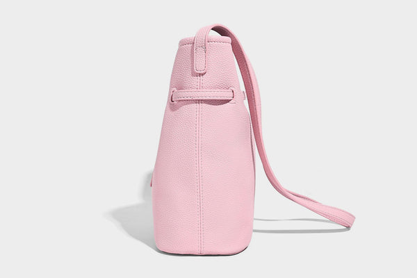 Small pebbled leather-look bucket bag with front drawstring toggle hardware and long adjustable shoulder strap, detail view