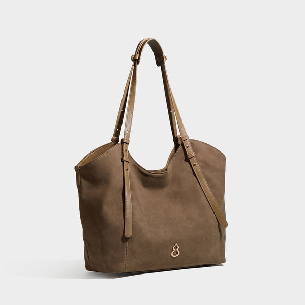 Oversized suede-finish tote shoulder bag in caramel brown with slim leather-look straps and gold-tone logo hardware, detail