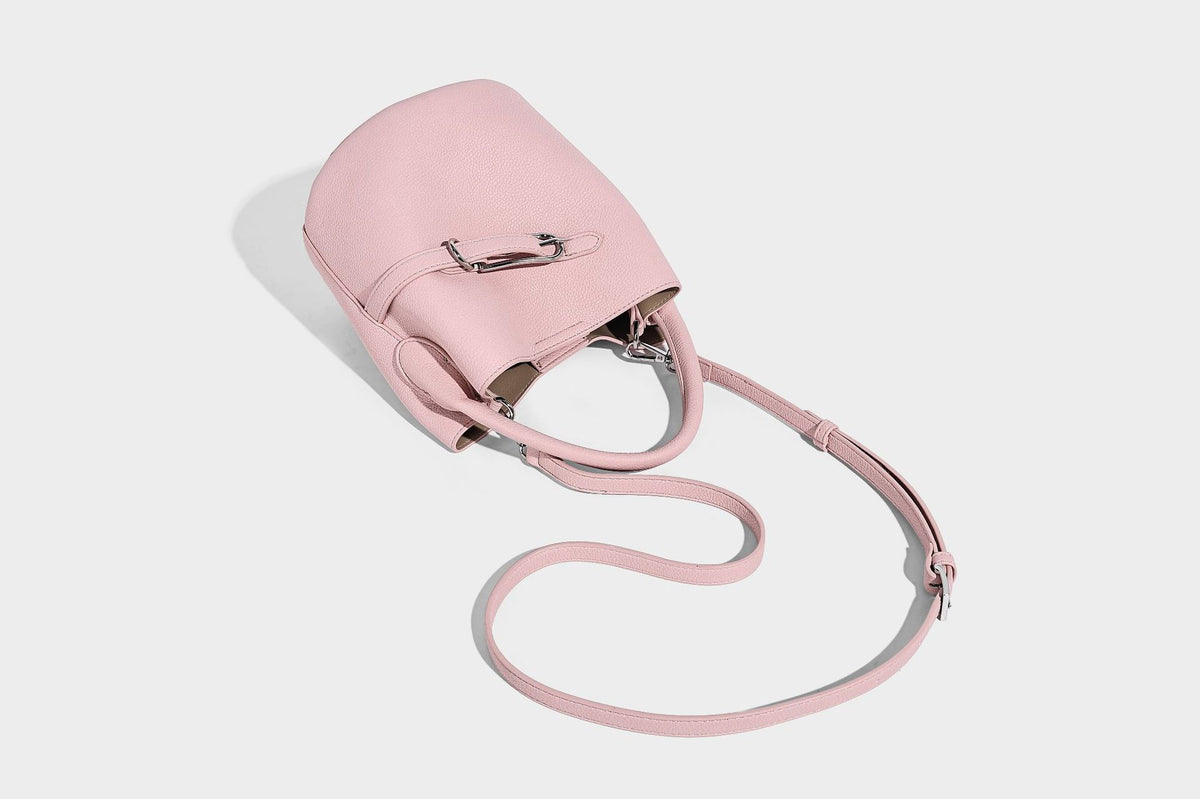 Mini pebbled leather-look bucket bag with front buckle strap, silver-tone hardware, top handle, and detachable shoulder