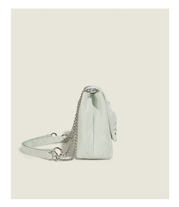 Structured rectangular chain shoulder bag with silver butterfly clasp and glossy crinkled finish, detail view 12