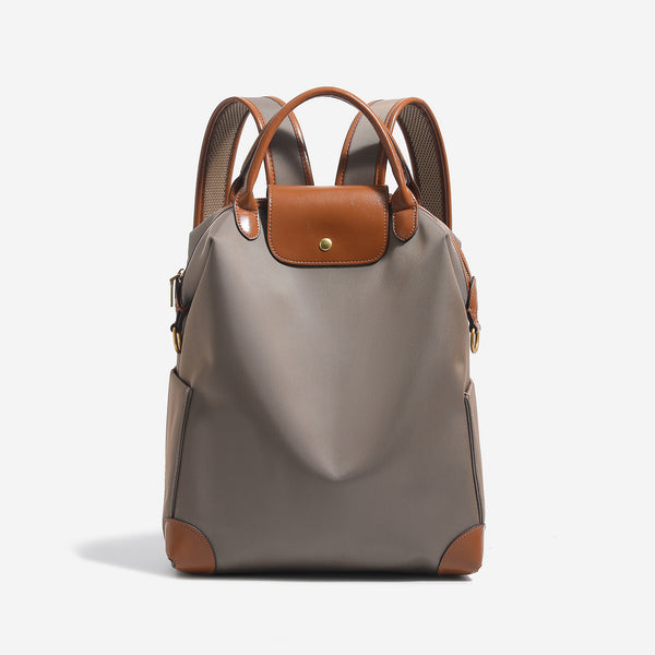 Large matte nylon backpack handbag with cognac leather-look trim, snap flap, and gold-tone hardware, detail view 8
