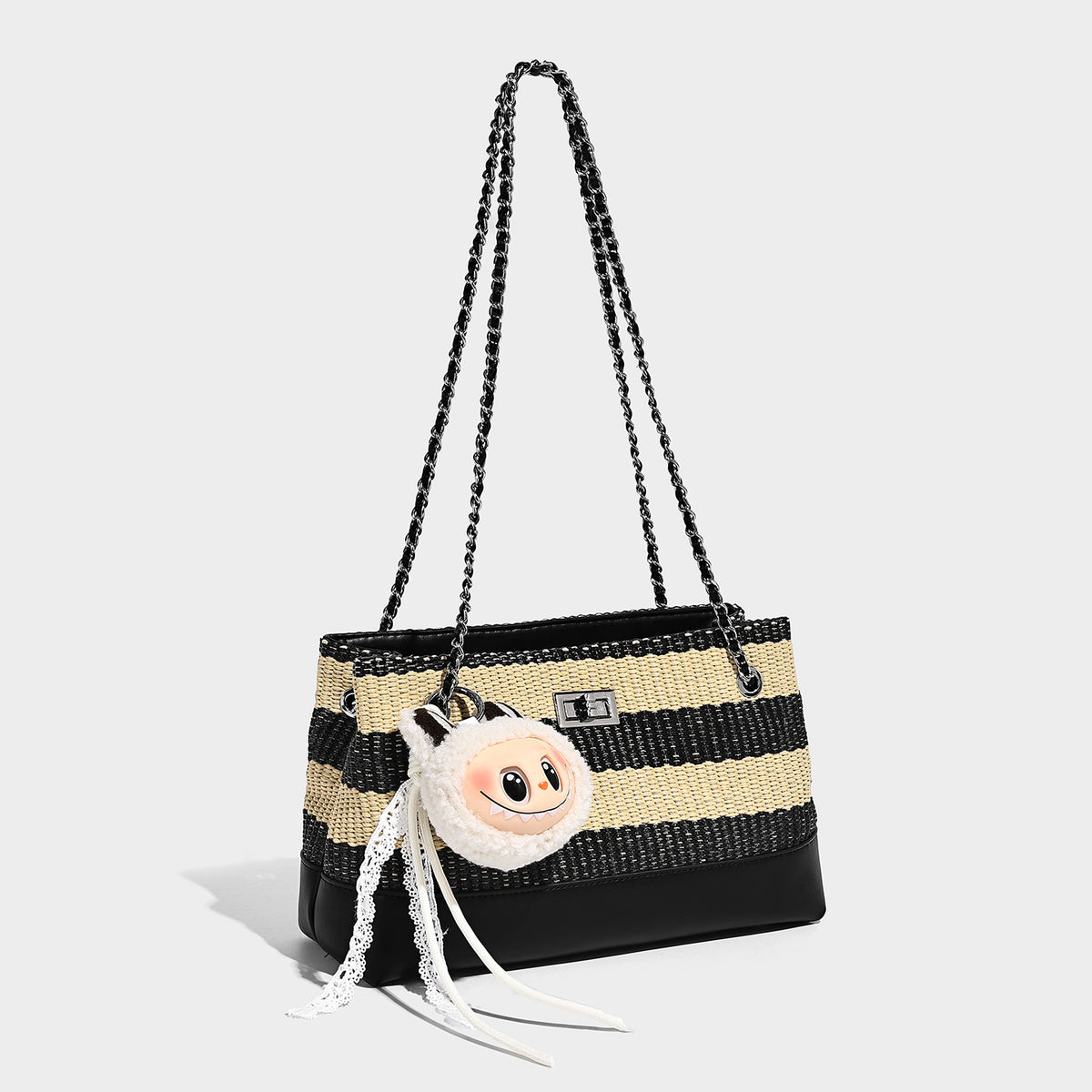 Structured black and beige striped woven shoulder bag with silver chain strap and turn-lock metal clasp, detail view 4