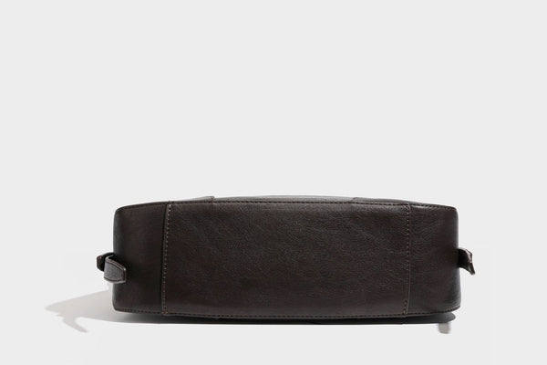 Slouchy crescent hobo shoulder bag in dark brown pebbled leather-look finish with zip top and long shoulder strap, detail