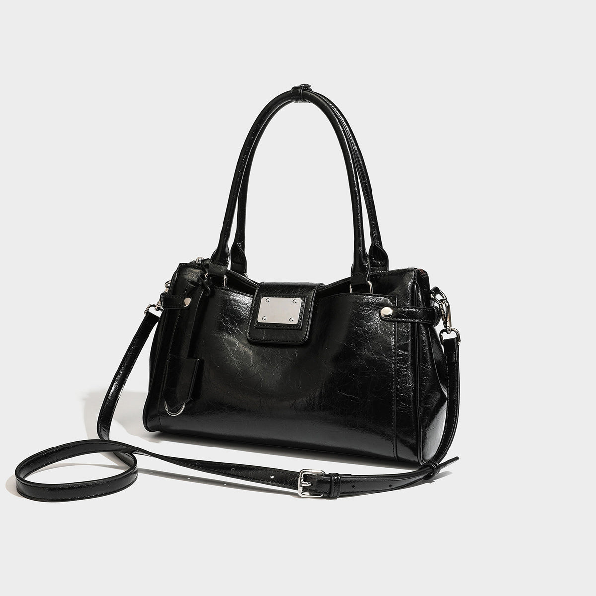 Structured glossy crinkled leather-look satchel with double top handles, front metal-plaque tab, silver-tone hardware, and
