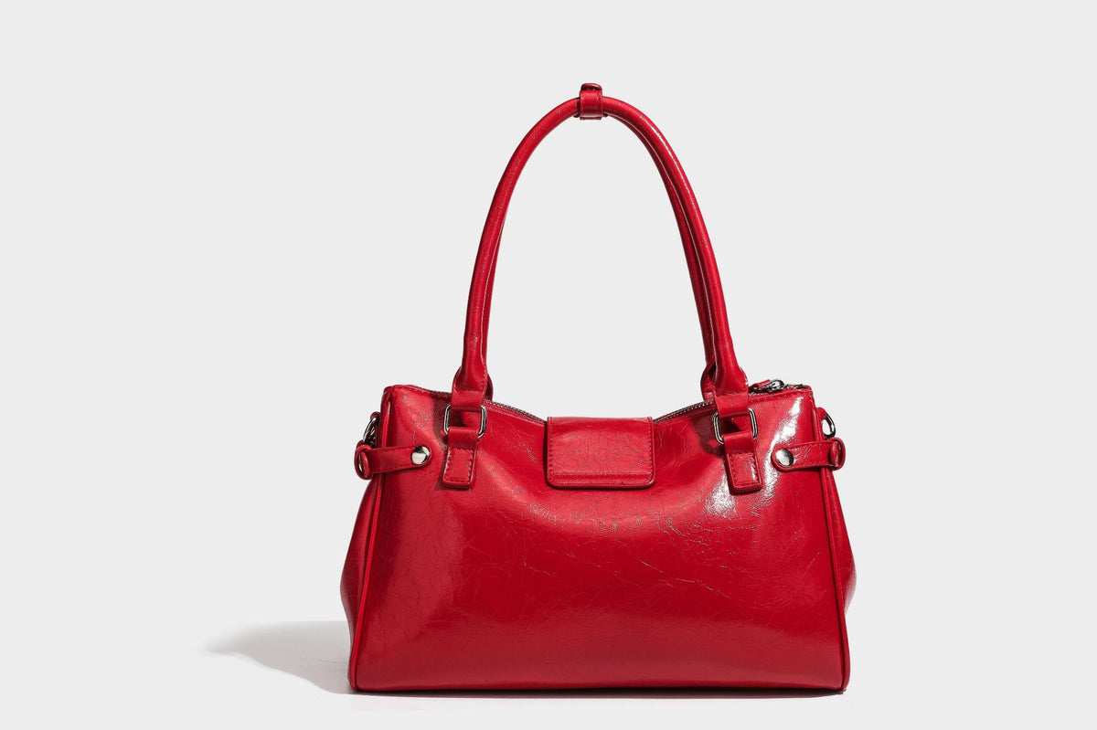 Structured glossy crinkled leather-look satchel with double top handles, front metal-plaque tab, silver-tone hardware, and