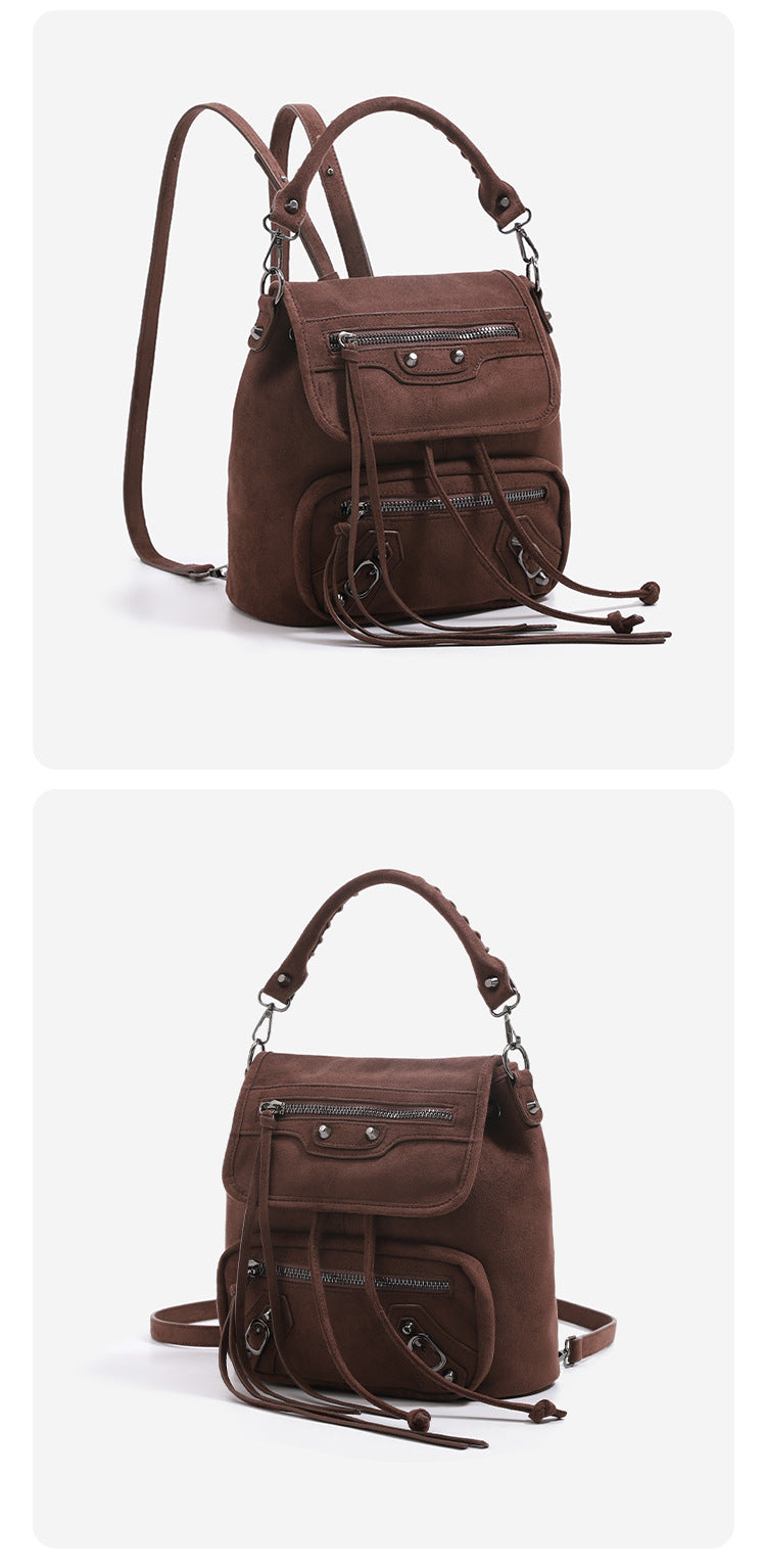 Mini flap backpack handbag with silver stud hardware, front zip pockets, and drawstring tassels, detail view 10