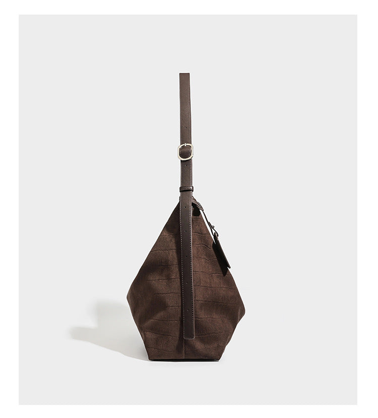 Slouchy hobo shoulder bag in matte croc-embossed leather-look finish with top zip closure and long adjustable strap, detail