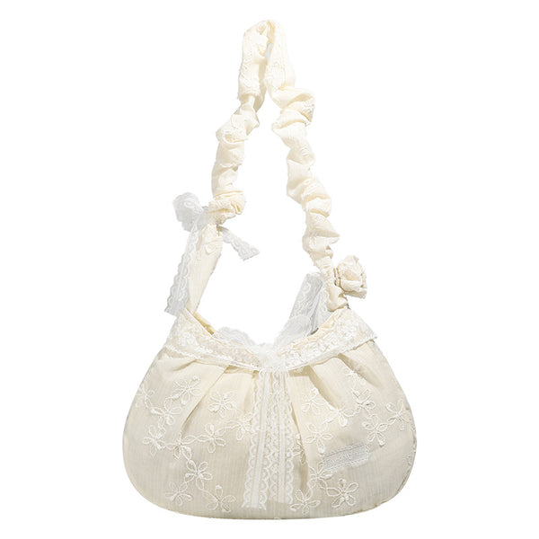 Elfenbeinfarbene, halbmondförmige Schultertasche mit Blumenstickerei, Spitzenbesatz und gerafftem Rüschenstoffriemen mit Schleifendetail, Detailansicht