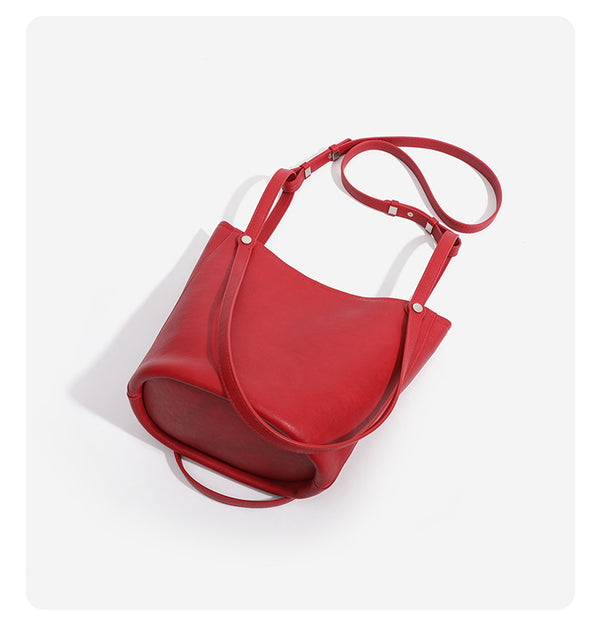 Large leather-look bucket tote bag with dual top handles and adjustable crossbody strap, detail view 15