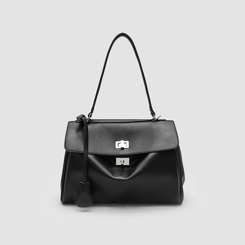 Structured black leather-look flap satchel bag with silver turn-lock hardware and top handle, front view