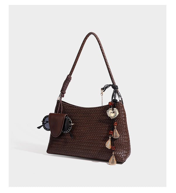Woven-texture hobo shoulder bag in brown with braided top handle, adjustable crossbody strap, front flap pocket, and, detail