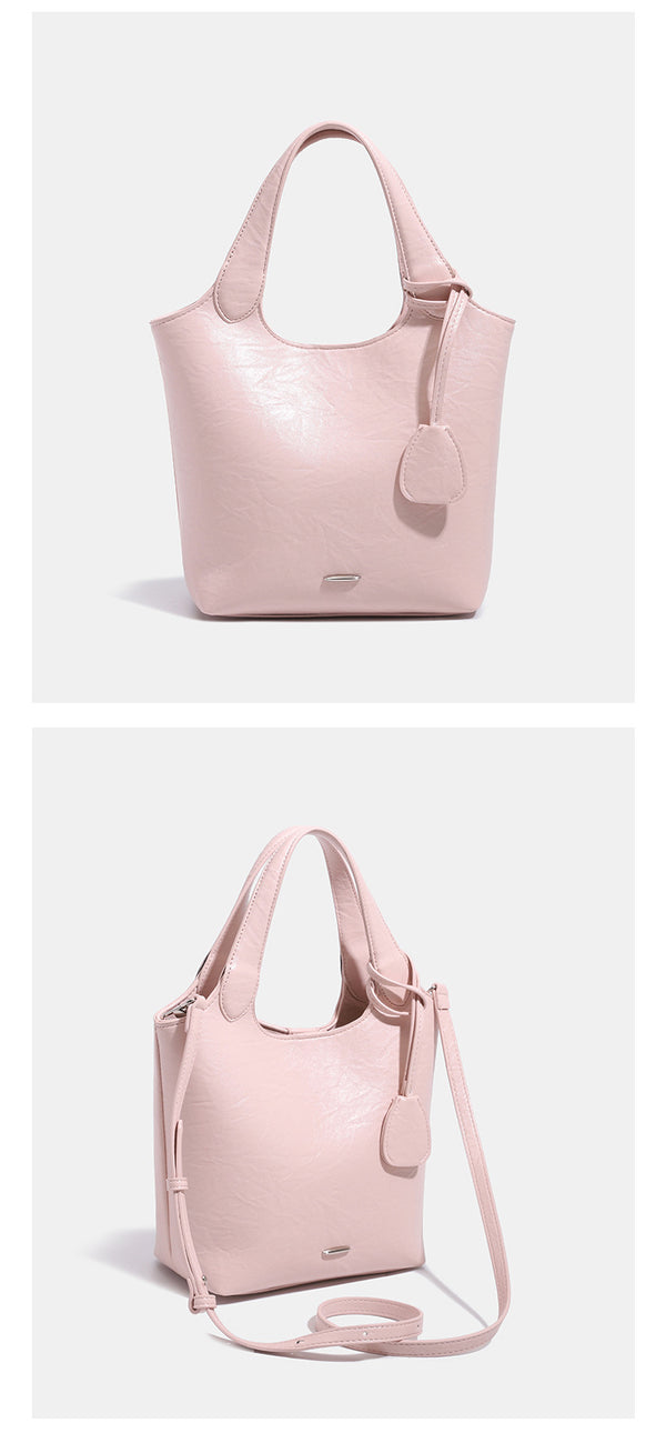 Soft glossy leather-look bucket tote bag with twin handles and detachable crossbody strap, detail view 10