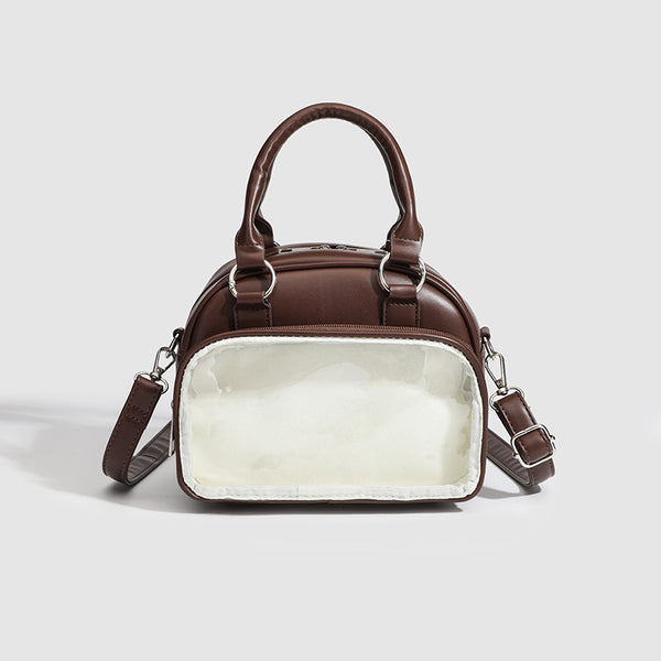 Structured mini bowling barrel bag with clear front pocket, dual top handles, and detachable crossbody strap in glossy