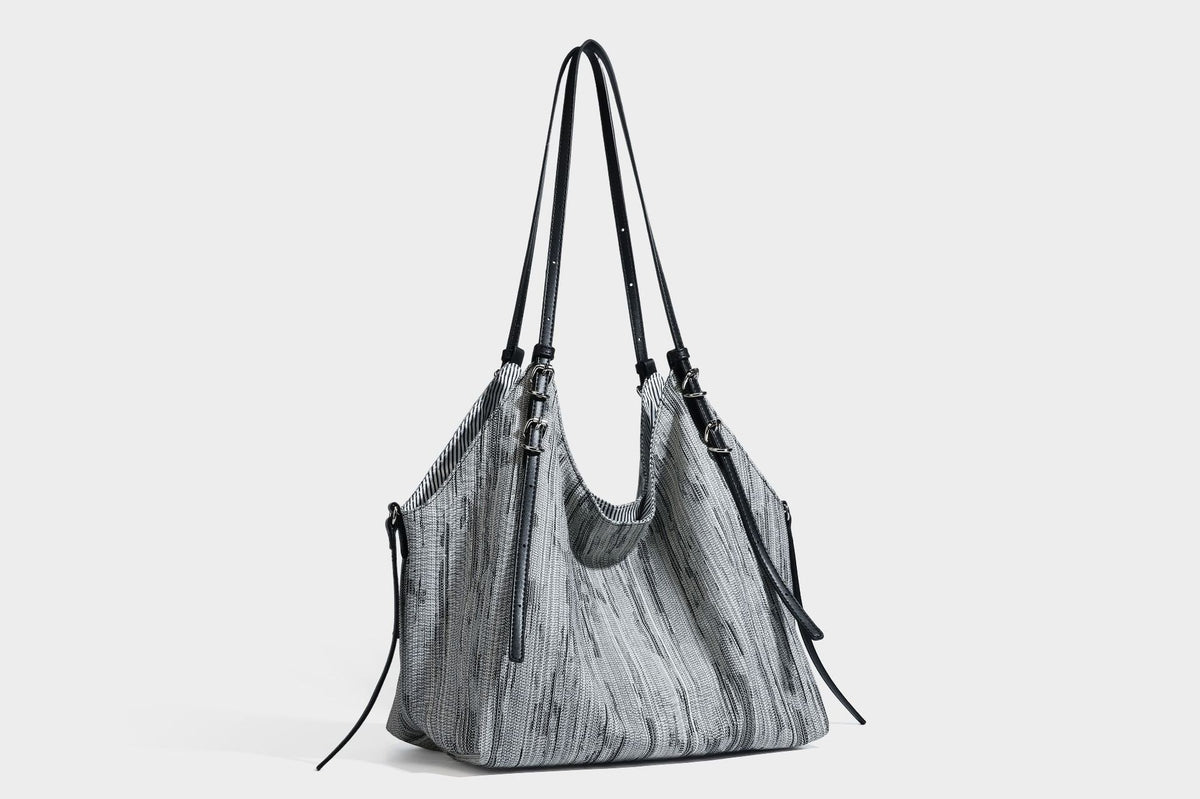 Large slouchy woven-texture shoulder tote bag with slim leather-look straps, side cinch ties, and silver-tone hardware