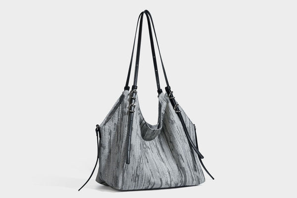 Large slouchy woven-texture shoulder tote bag with slim leather-look straps, side cinch ties, and silver-tone hardware