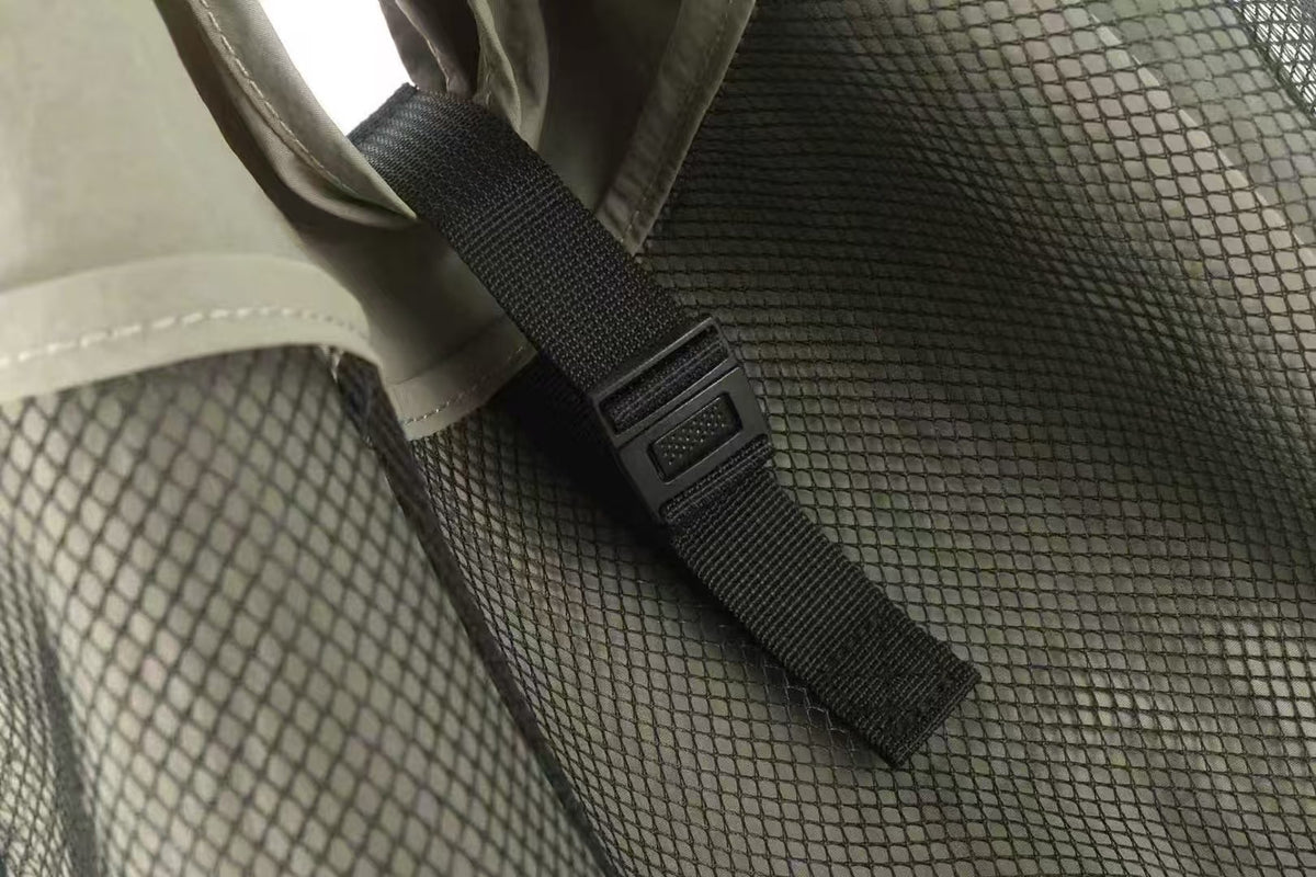 Oversized triangular mesh tote bag with matte olive-khaki fabric straps and trim, dark open-weave mesh body, matte black