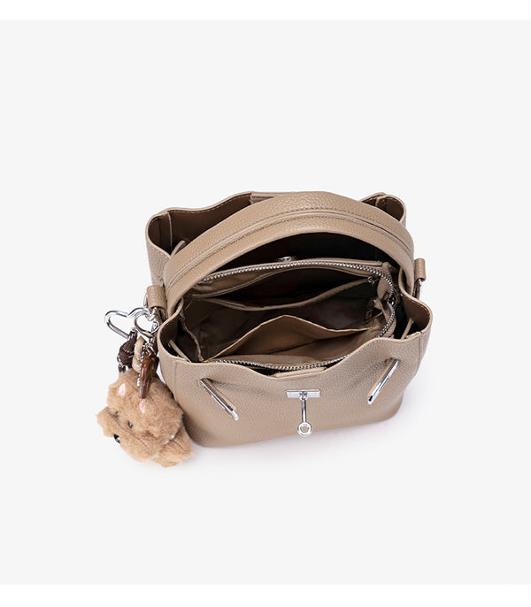 Compact structured bucket bag in pebbled leather-look finish with silver turn-lock front clasp, dual top handles, detachable