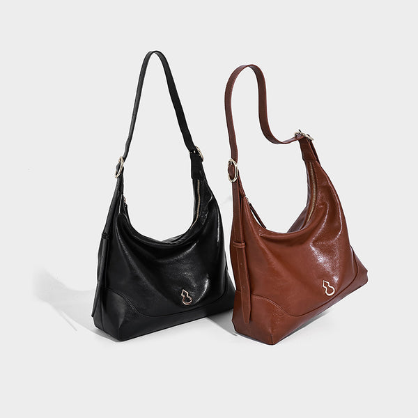 Glossy leather-look slouchy hobo shoulder bag with zip closure, gold-tone hardware, and adjustable strap, detail view 2