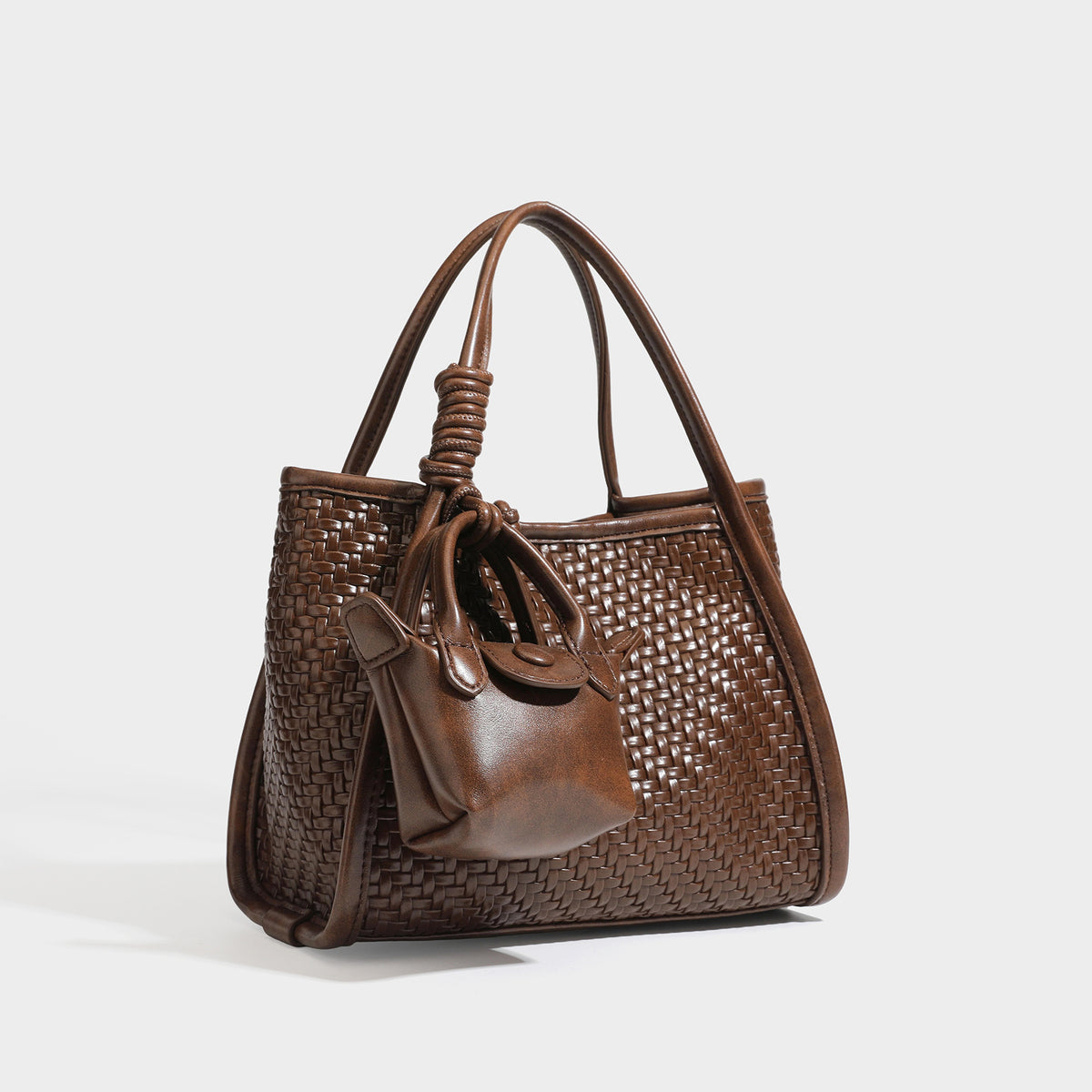 Strukturierte Tote Bag mit Webstruktur in Braun, glatten Besätzen in Lederoptik, geknoteten Tragegriffen und befestigtem Mini-Beutel mit Kordelzug