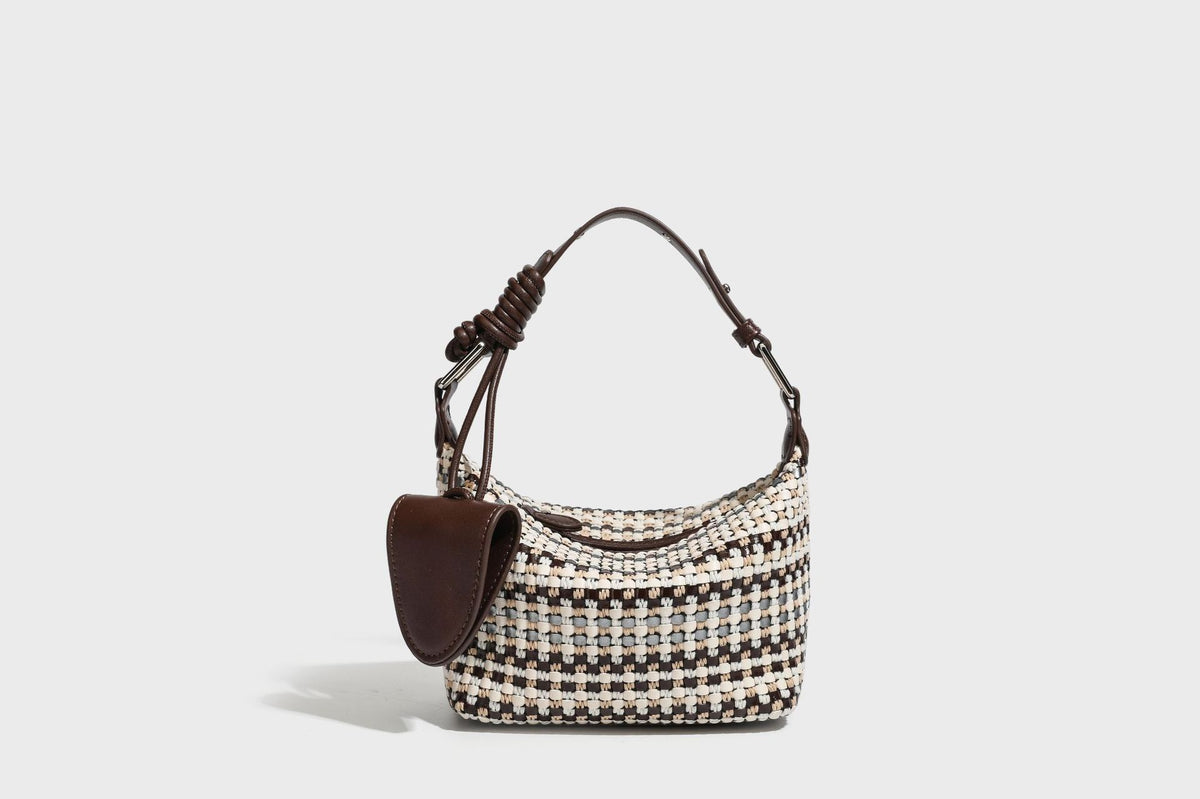 Small crescent shoulder bag in black-and-white woven textile with smooth black leather-look trim, zip-top closure, knotted