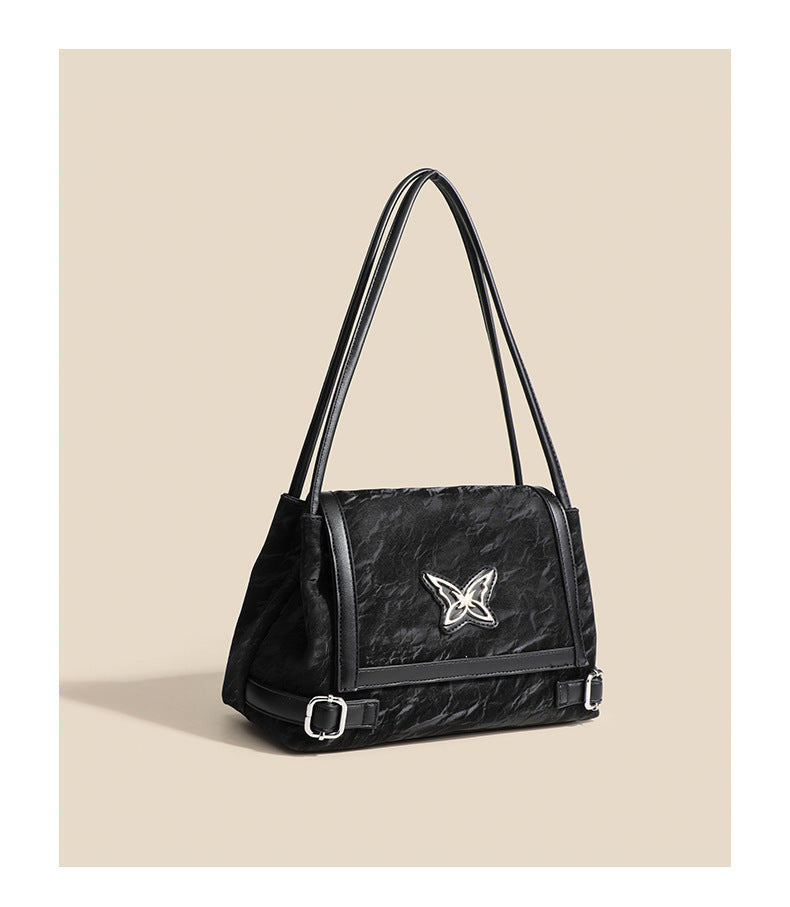 Structured crinkle-finish flap shoulder bag with butterfly metal appliqué and dark brown contrast trim, detail view 10