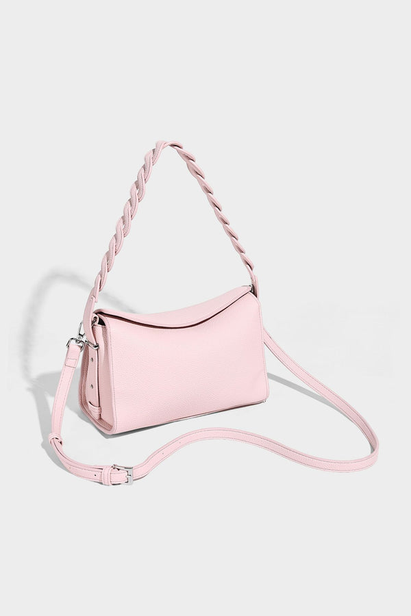 Small structured pebbled-finish shoulder bag with braided top handle, detachable crossbody strap, floral tassel charm, and