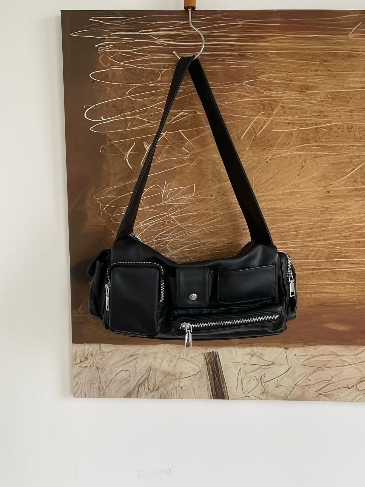 Slouchy multi-pocket leather-look shoulder bag with silver-tone hardware and adjustable strap, detail view 6