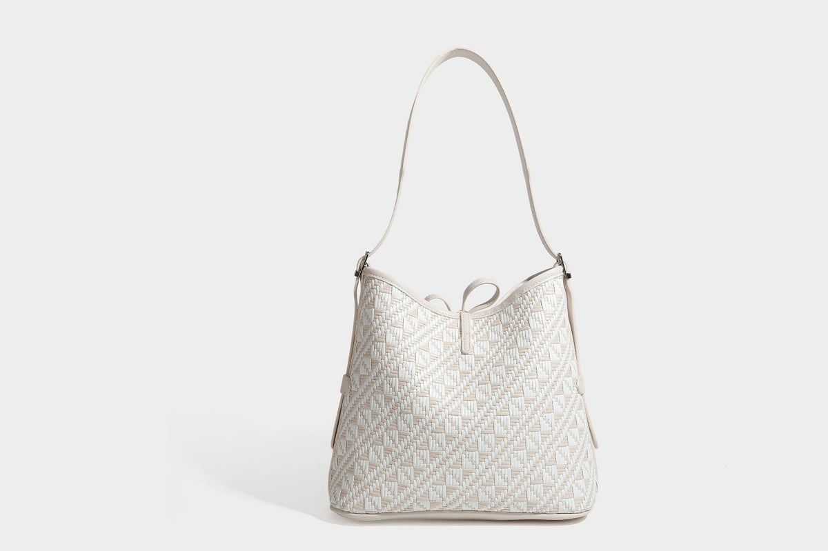 Woven geometric bucket shoulder bag in white and dark brown two-tone pattern with leather-look trim and drawstring top