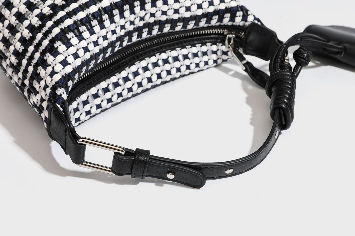 Small crescent shoulder bag in black-and-white woven textile with smooth black leather-look trim, zip-top closure, knotted