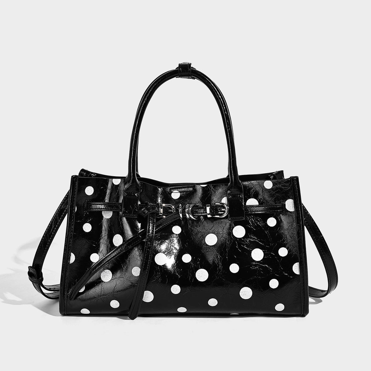 Structured glossy polka-dot tote bag with double top handles and front buckle hardware, detail view 6