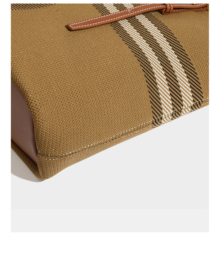 Large structured plaid check tote bag with smooth tan leather-look shoulder straps, attached front zip pouch, and gold-tone
